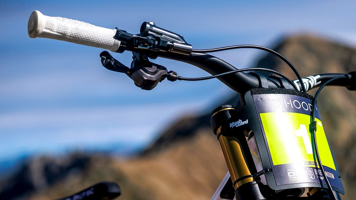 White Goldstone Grips fitted to a downhill bike outdoors