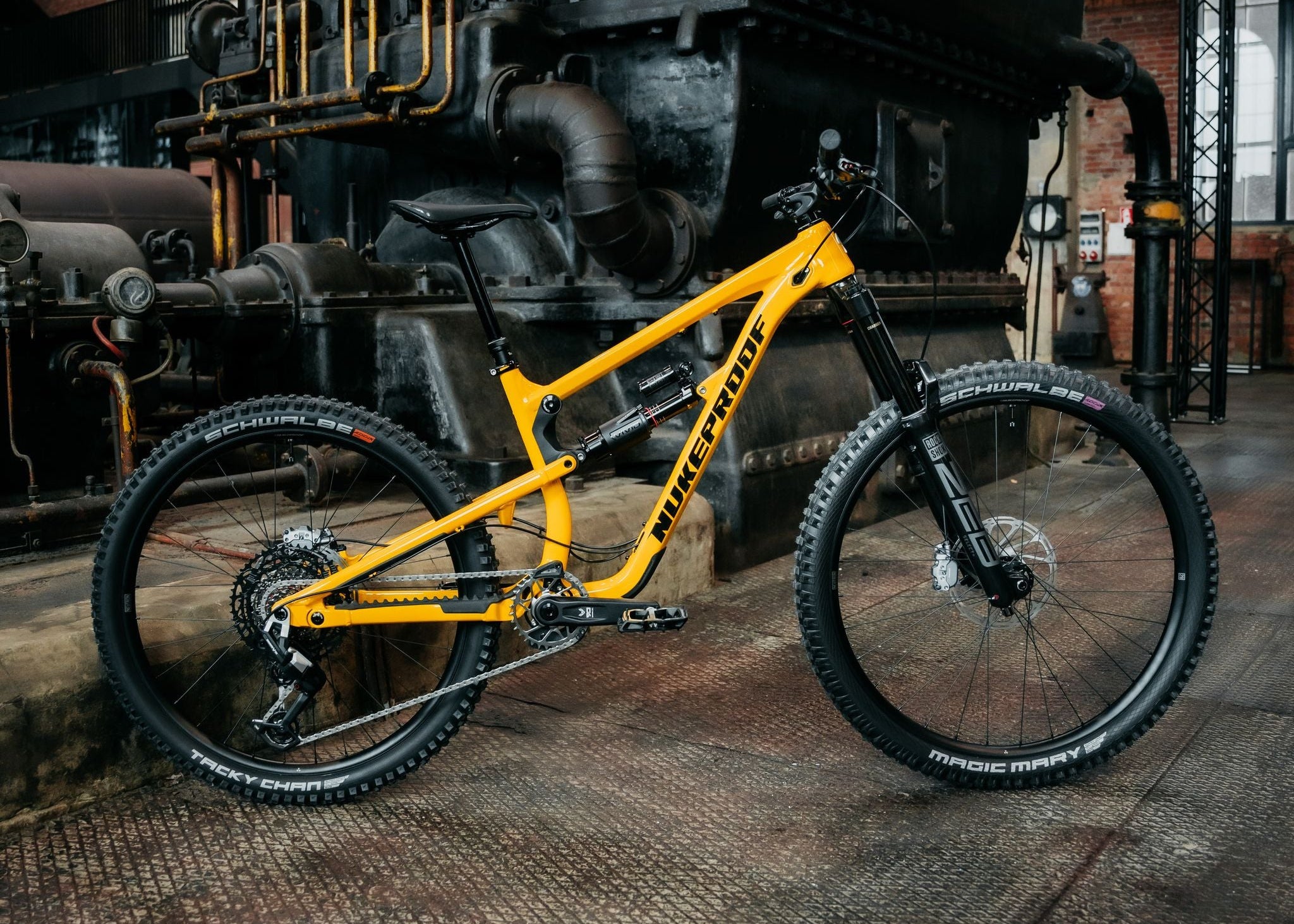 Yellow mountain bike in a large industrial warehouse.