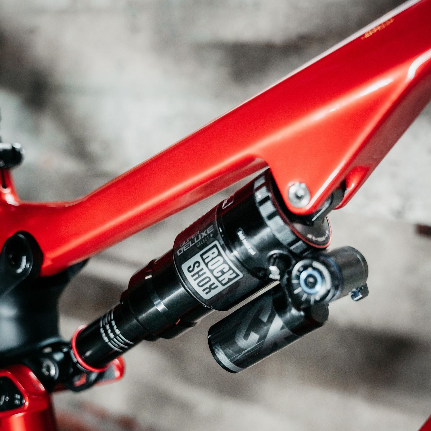 Close-up of a red bicycle frame with a blurred background