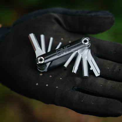 Open OneUp EDC multi-tool held in a glove