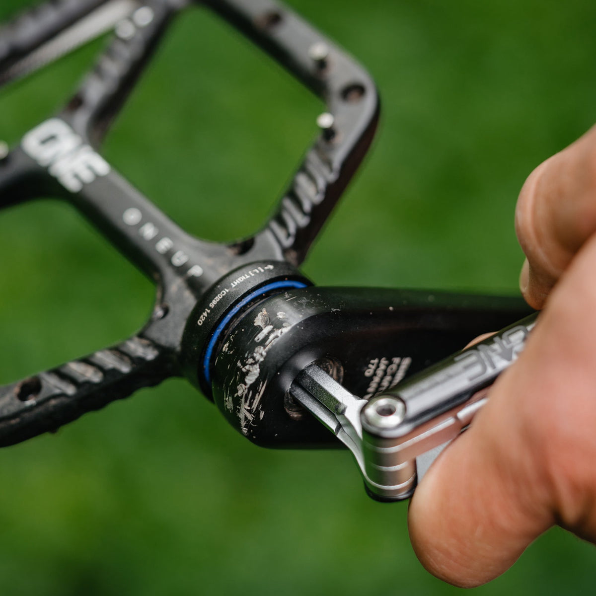 OneUp EDC multi-tool being used at a crank bolt