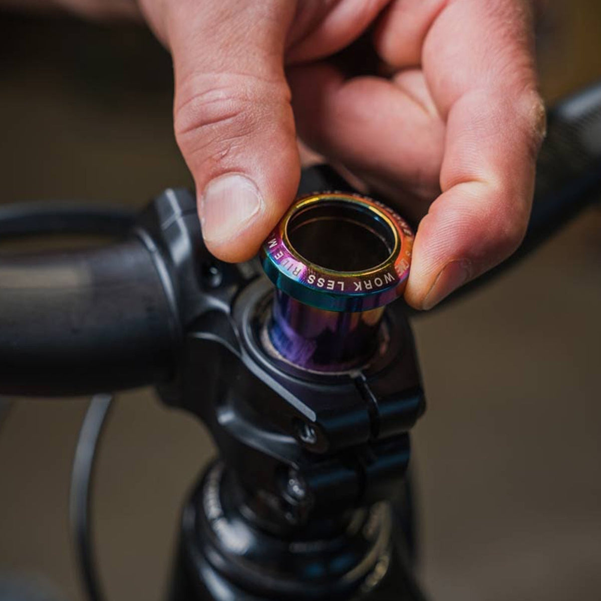 OneUp Threadless Carrier being placed in a fork steerer