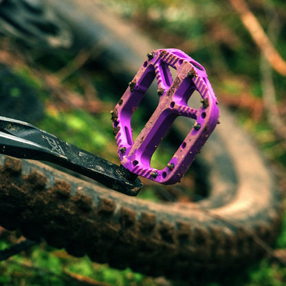 Purple OneUp Composite Pedal installed on a trail bike