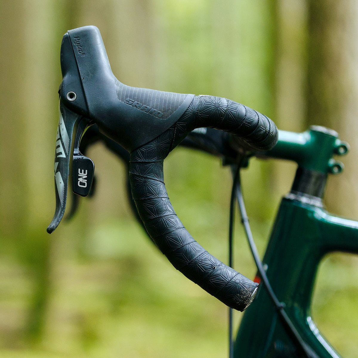 OneUp Drop Bar Paddle Remote fitted inside a SRAM hood outdoors