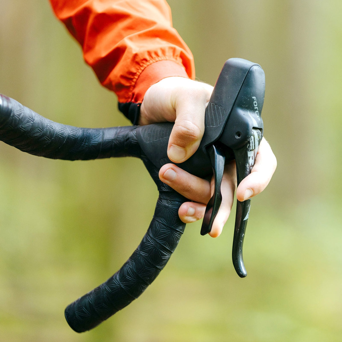 Rider operating the OneUp paddle from the brake hood