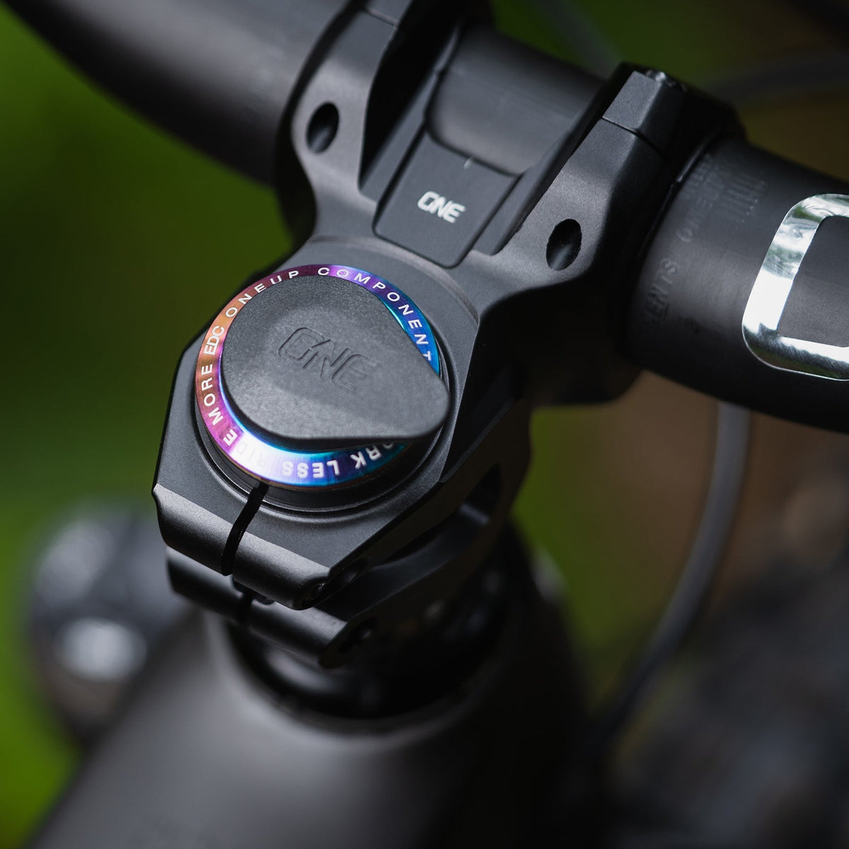 Oil-slick OneUp EDC Threaded Top Cap installed in a cockpit