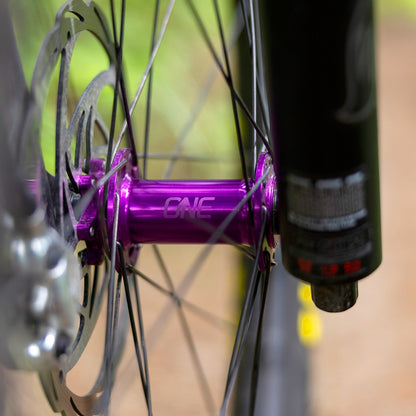 Purple OneUp Front Hub installed in a fork and wheel