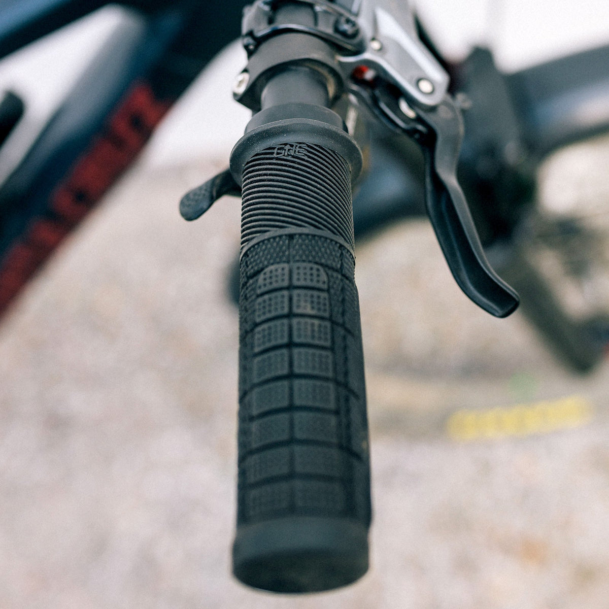 Installed black OneUp Thick Grip showing the padded palm surface