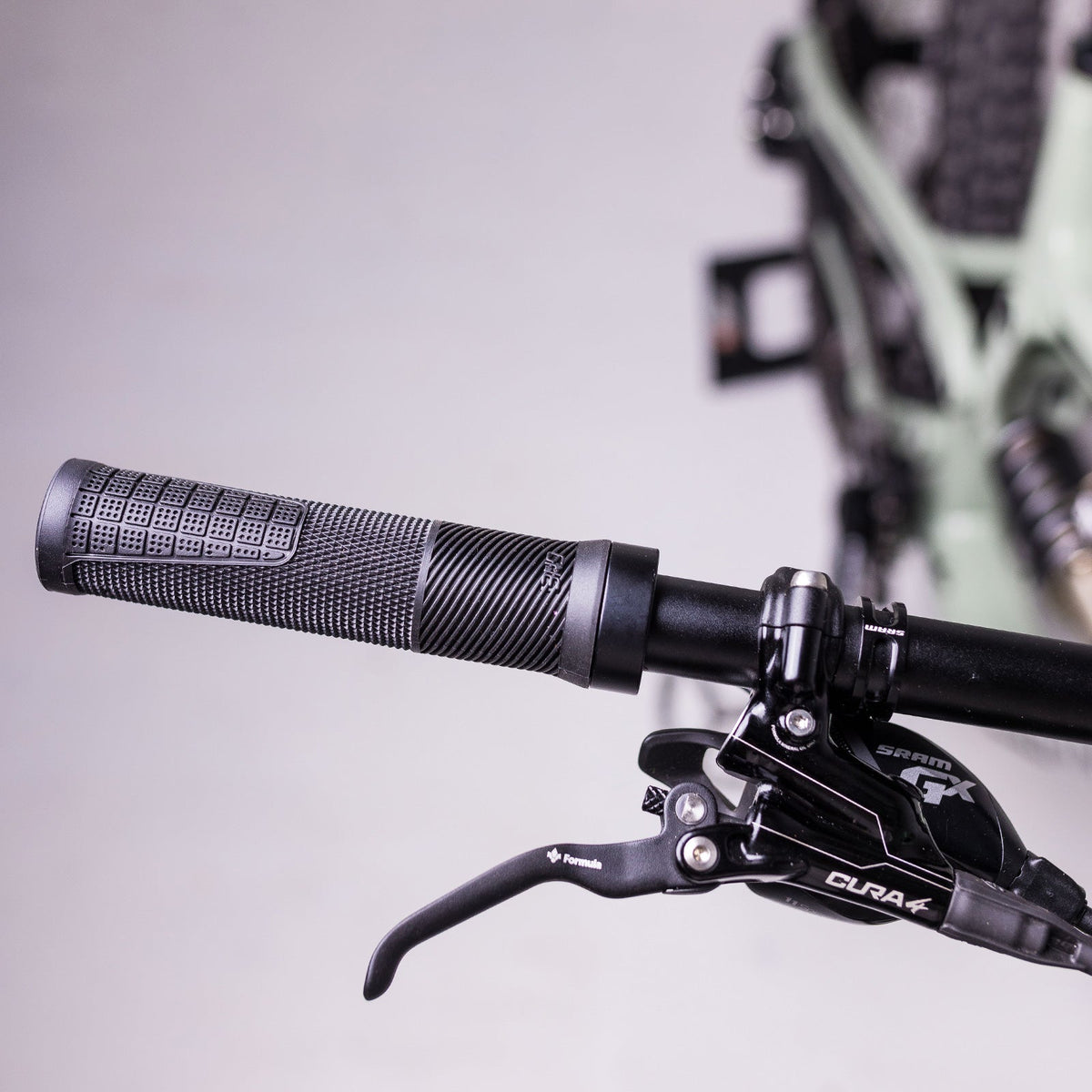 Black OneUp Thin Grip fitted to a handlebar