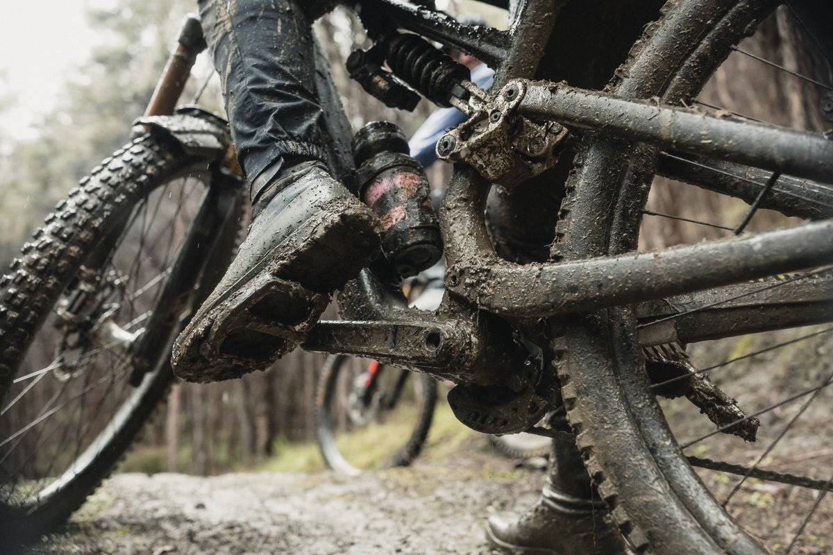 Crankbrothers Mallet Trail Speed Lace Seal Shoes in Dark Grey / Forest on a wet trail; cleats and pedals not included