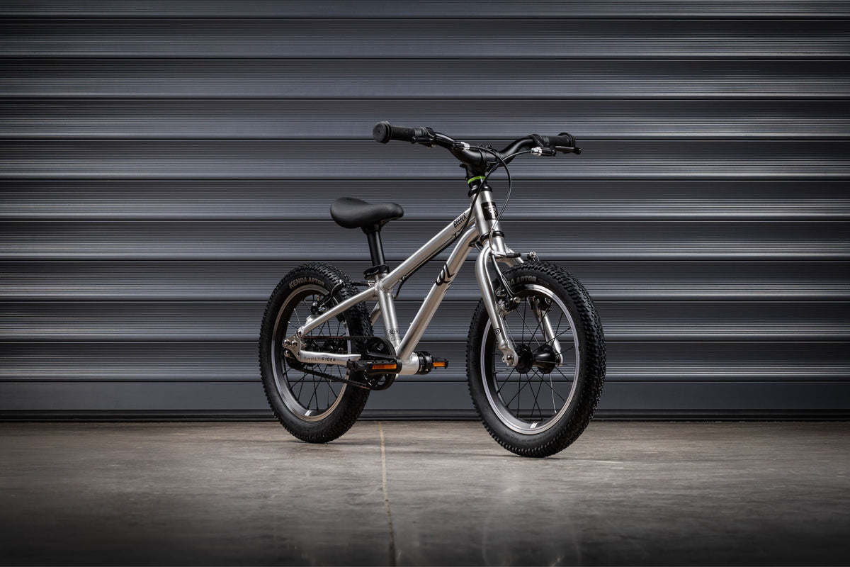 Early Rider Belter 14 in Brushed Aluminium against grey shutters