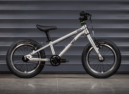 Early Rider Belter 14 in Brushed Aluminium - whole-bike drive-side profile against grey shutters