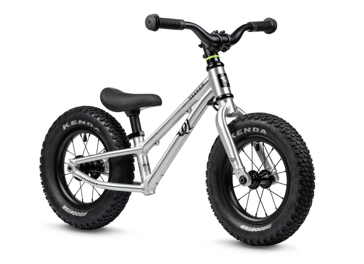 Early Rider Seeker 12 Balance Bike in Brushed Aluminium - brushed balance bike on white with knobbly tyres and no fitted brake