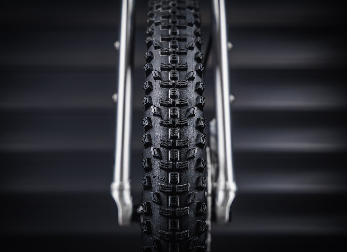 Early Rider Seeker 14 in Brushed Aluminium - front Kenda Booster tread between rigid fork legs