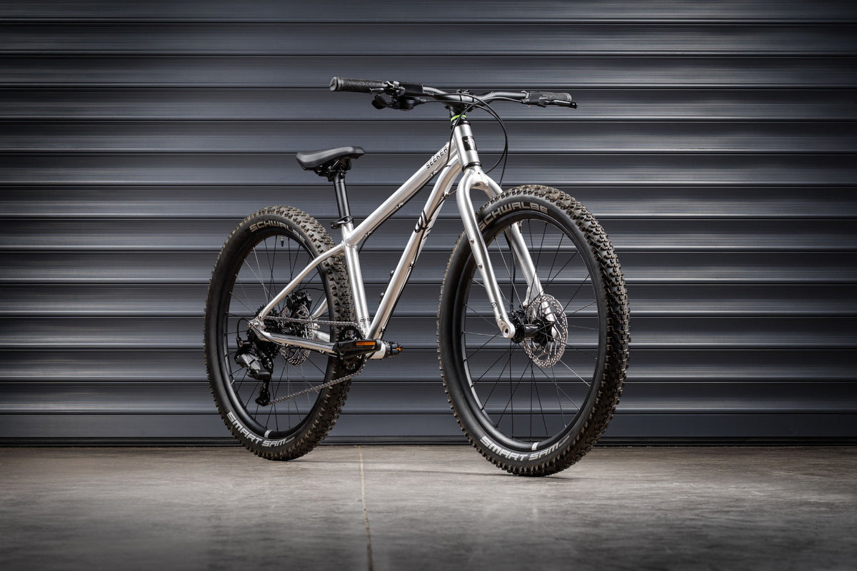 Early Rider Seeker 24 in Brushed Aluminium against grey shutters