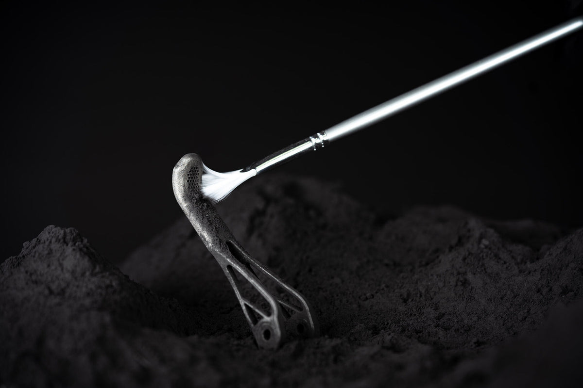 Brush clearing powder from a textured titanium brake lever blade.
